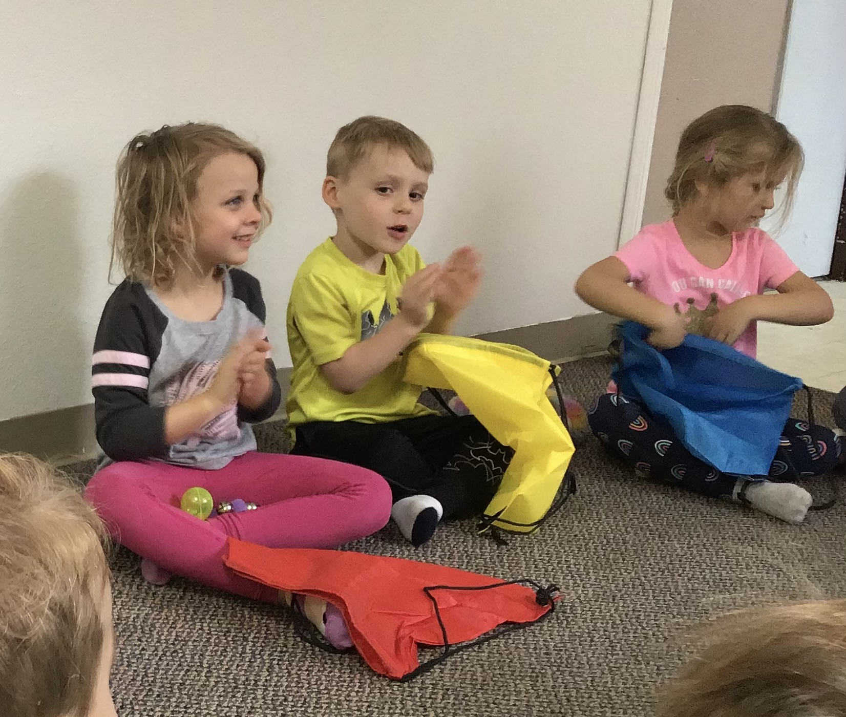 Young students clapping along during a music class